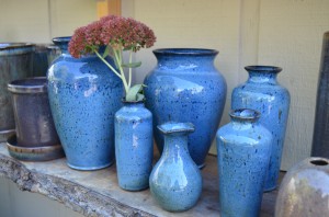 Horticulturist and local potter, Jimmy Richardson of Hemphill Pottery, creates unique stoneware pottery with a wood ash glaze for retail at Grass Root Gardens.  - Buy Haywood Photo